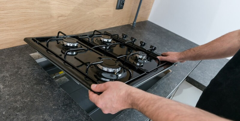 Professional installing a gas cooktop