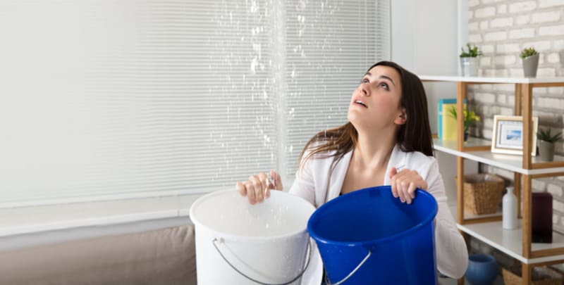 Woman coping with a burst pipe